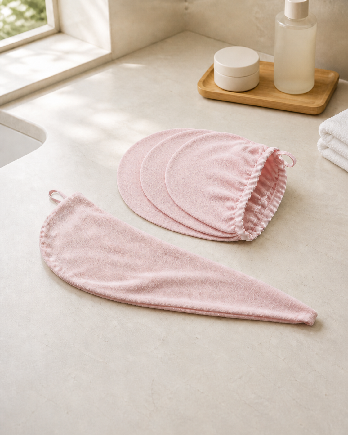 Blush Mauve Luma 3-layer hair towel wrap with inner panels laid open on bathroom counter